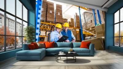 Senior woman manager and man worker working in a warehouse. Wall mural