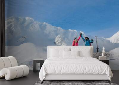 Ski touring couple high fiving on the top of mountain in the Low Tatras in Slovakia. Wall mural