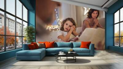 Small girl with parents and grandparents indoors celebrating Christmas. Wall mural