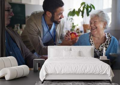 Smiling elderly woman and man enjoying breakfast in nursing home care center. Wall mural