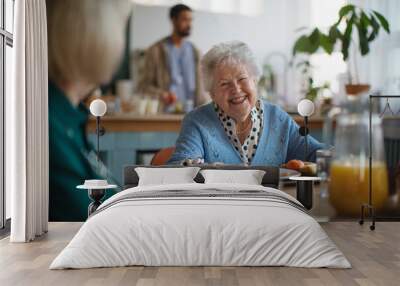 Smiling elderly woman enjoying breakfast in nursing home care center. Wall mural