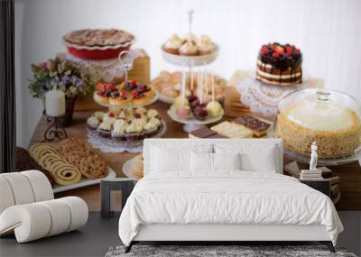 Table with various cookies, tarts, cakes, cupcakes and cakepops Wall mural