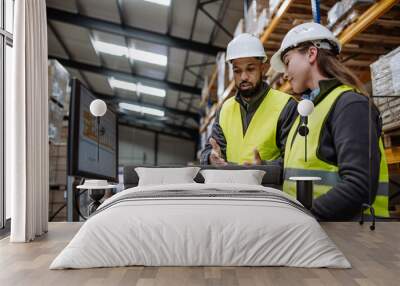 Warehouse manager talking with logistics employee in warehouse, planning transport of products, talking shipping process. Wall mural