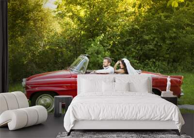 Wedding car with bride and groom Wall mural