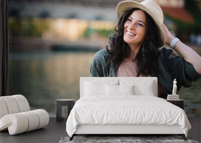 Woman candid portrait from park. Young urban female tourist smiling . Wall mural