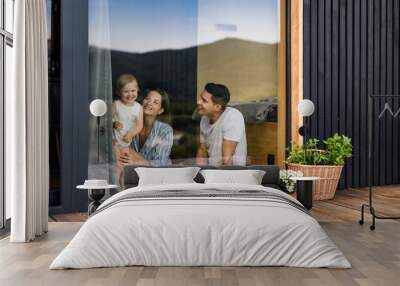 Young family with small daughter indoors, weekend away in container house in countryside. Wall mural