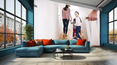 Young family with two children going on a holiday. Wall mural