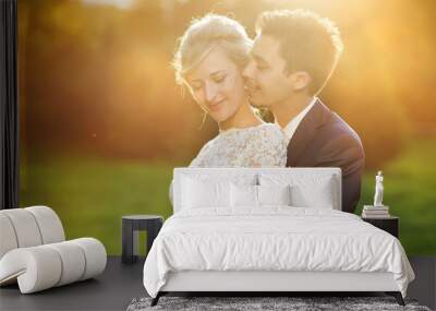 Young wedding couple on summer meadow Wall mural