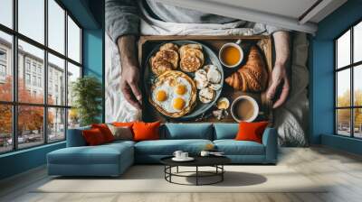 Hands hold a pancake and egg breakfast plate Wall mural