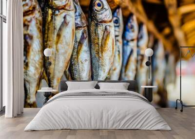 In a special metal container, mackerel is prepared for smoking. Wall mural