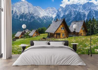 In the scenic Gasienicowa Valley of the Tatra Mountains, a picturesque summer landscape features wildflowers and traditional cottages. Wall mural