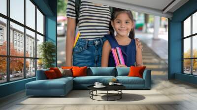 It's the first day of school. A mother leads her first-grade daughter to school. Wall mural