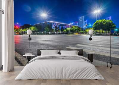 empty road with zebra crossing and skyscrapers in modern city at night Wall mural