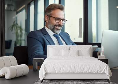 A middle-aged businessman sits at his desk in an office Wall mural