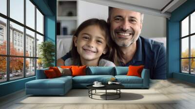 Portrait of a happy father and daughter sitting on the couch Wall mural