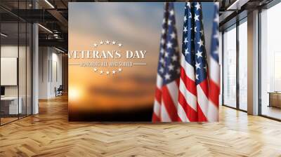 American flags with Text Veterans Day Honoring All Who Served on sunset background. American holiday banner. Wall mural