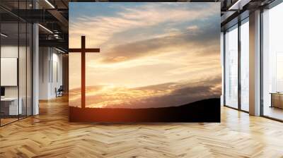 Christian cross on hill outdoors at sunrise. Resurrection of Jesus. Concept photo. Wall mural