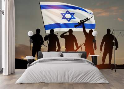 Silhouettes of soldiers with Israel flag against the sunrise in the desert. Concept - armed forces of Israel. Wall mural