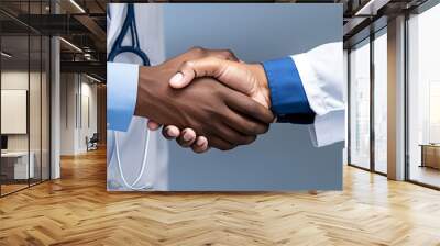 a close-up of two people shaking hands, one wearing business clothes and the other a medical coat, signifying confidence between a businessman and a doctor during a crucial meeting.  Wall mural