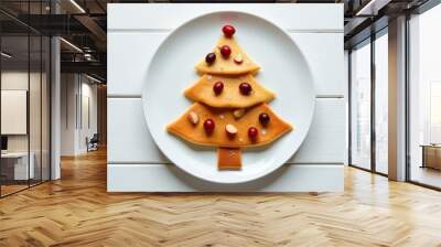 A Christmas tree of pancakes lies on a white plate. Wall mural