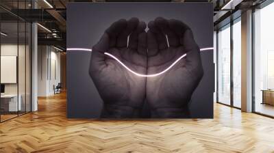 Neon Light Thread - Wire in Open Hands on Dark Background. Creativity and Energy Concept. Wall mural