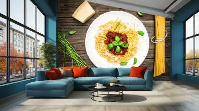 Spaghetti with Basil Leaves, Cheese and Tomato Sauce on Wooden Background Wall mural