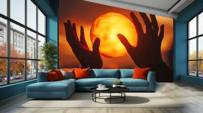 Silhouetted Hands Holding a Glowing Orb Against a Sunset Sky Wall mural