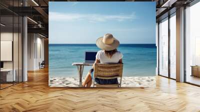 young woman view from back using laptop computer and is sitting and working by the sea, beautiful view to the ocean - Generative AI Wall mural