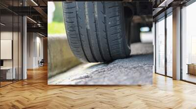 Car wheel on the edge of the road Wall mural