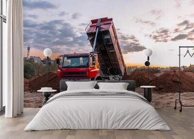 A dump truck is dumping gravel on an excavation site Wall mural