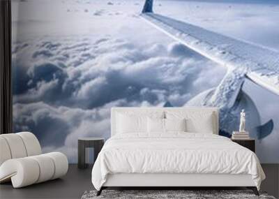 A jet engine is seen in the sky with clouds Wall mural