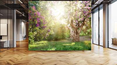 beautiful landscape with old lilac tree blossoming in the garden. Lilac bushes under bright sun rays Wall mural