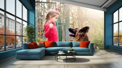 Pretty little girl, training, german shepherd dog. Wall mural