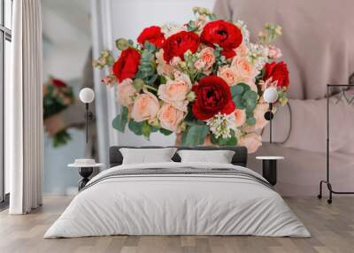 Amazing bouquet of red peonies and flowers for the bride for the wedding in the hands of a girl Wall mural