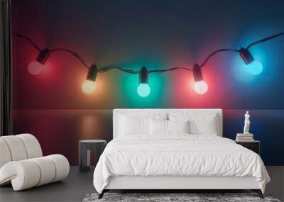 Colored Christmas glowing light garland. Garland with led lamps shining on dark background. Wall mural