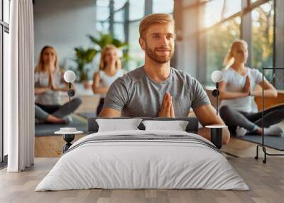 group of people doning yoga; fitness; gym; yoga class; a man doing yoga Wall mural