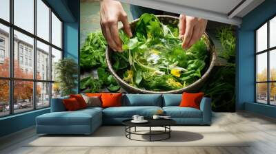 A person adding kelp to a salad bowl with various fresh greens Wall mural