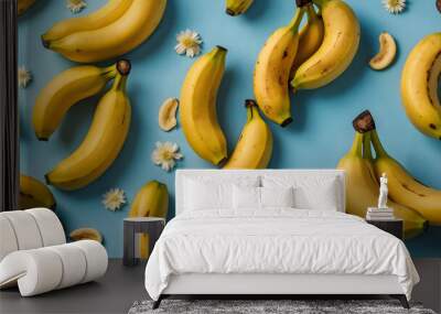 A vibrant arrangement of fresh bananas on a light blue background, showcasing their bright yellow color and healthy appeal. Wall mural