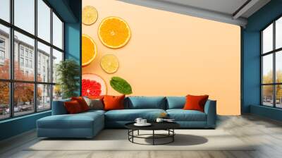 summer background concept: sliced orange, grapefruit, lemon, lime, mint on orange background Wall mural