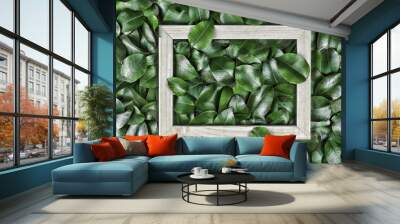 Creative layout made of leaves with paper card note or frame. A flat lay. Nature concept Wall mural