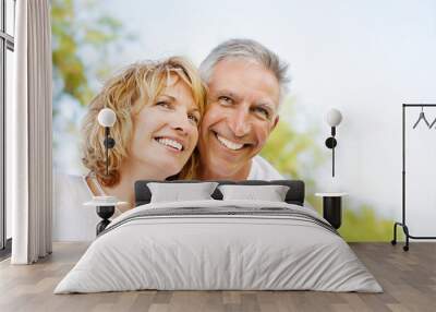 Mature couple smiling and embracing. Wall mural