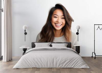 Portrait of a beautiful young asian woman smiling against white background Wall mural