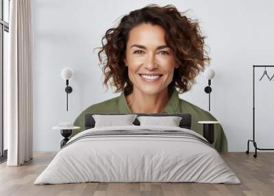 Portrait of happy young woman smiling at camera over white background. Wall mural