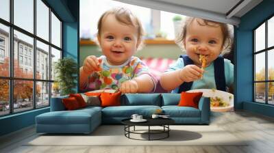 Two happy infants tasting vegetables with a smile Wall mural