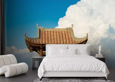 Asian oriental Buddhism temple roof against blue cloudy sky Wall mural