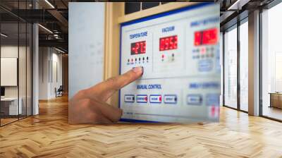 Man hand the controls of a modern machine Wall mural