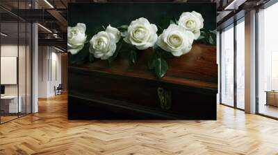 A traditional wooden coffin with white roses placed delicately on top Wall mural