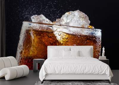 Cola drink fizz with ice in a glass Wall mural