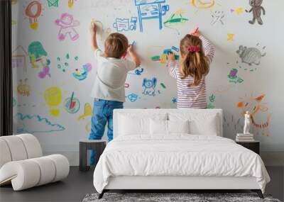 Two children drawing with colors on a white wall with various child drawings Wall mural