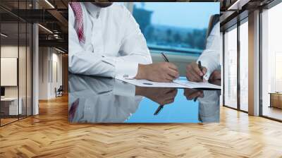 Two Saudi Businessmen Hands Signing A Ducument Wall mural